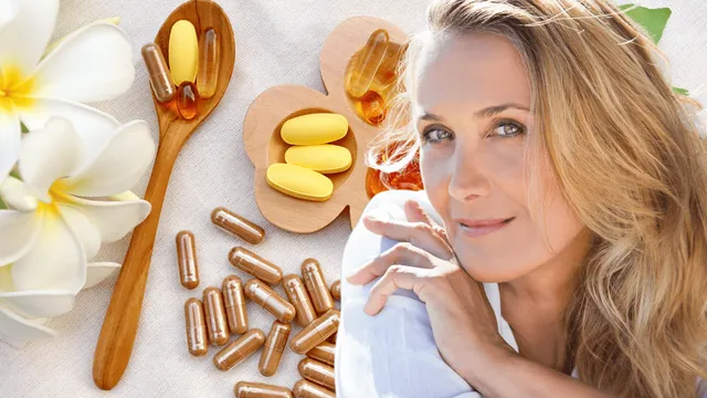 Woman relaxing in soft sunlight beside wooden trays and spoon filled with yellow tablets and amber capsules, symbolizing natural supplements for menopause joint pain relief.