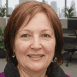 Middle‑aged woman with shoulder‑length brown hair smiling in a modern office, Lonage healthy aging testimonial photo.