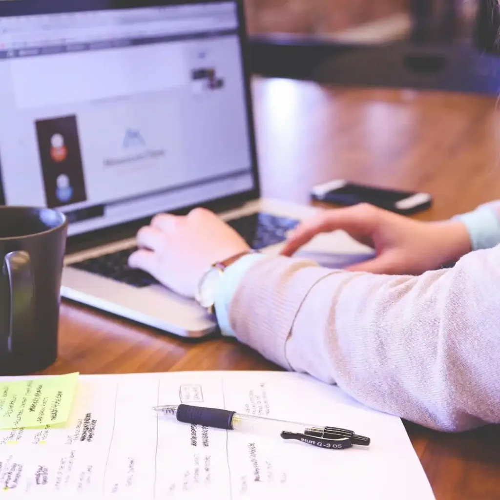 Woman over 50 strategically planning her life reinvention with notes and vision materials.