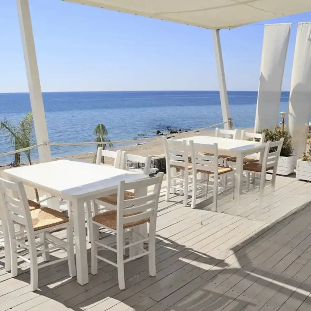  Peaceful seaside café tables overlooking Mediterranean during quiet off-peak season
