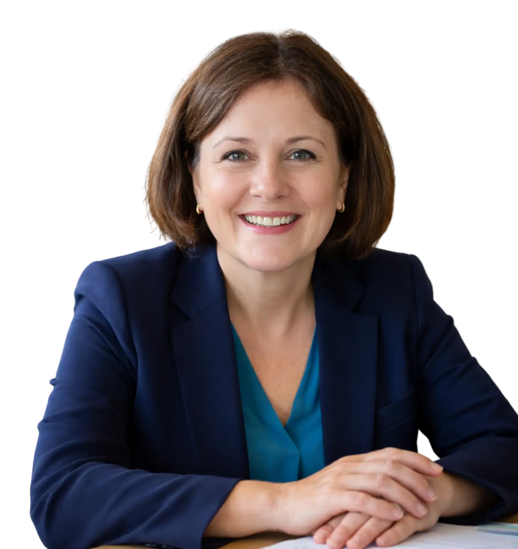 Professional woman with brunette hair wearing a green blouse, smiling gently and posing confidently.