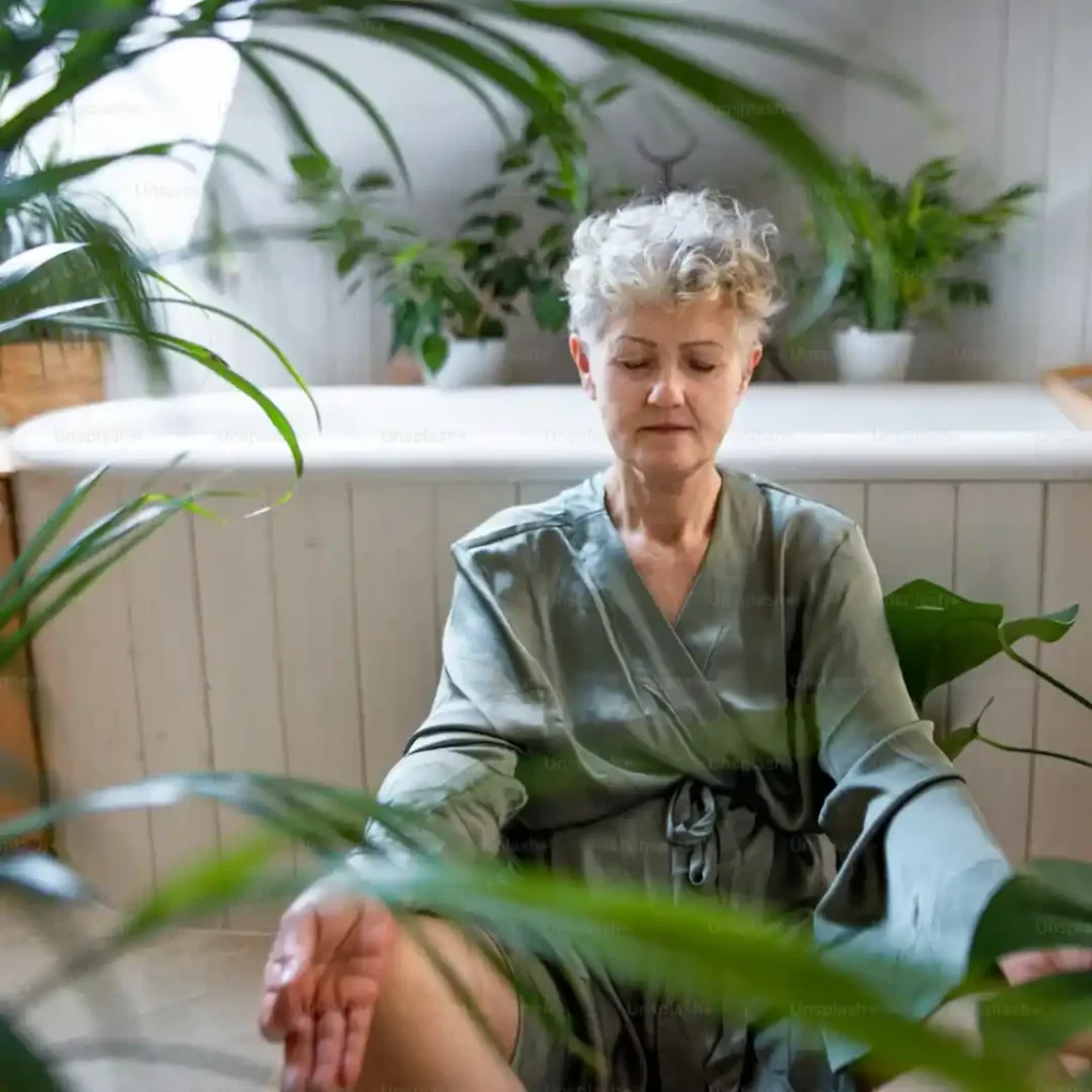 Peaceful woman over 50 experiencing relaxation and mindfulness during evening routine