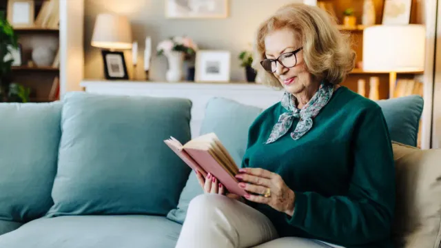 Woman in her late 50s relaxing at home after an evening walk.